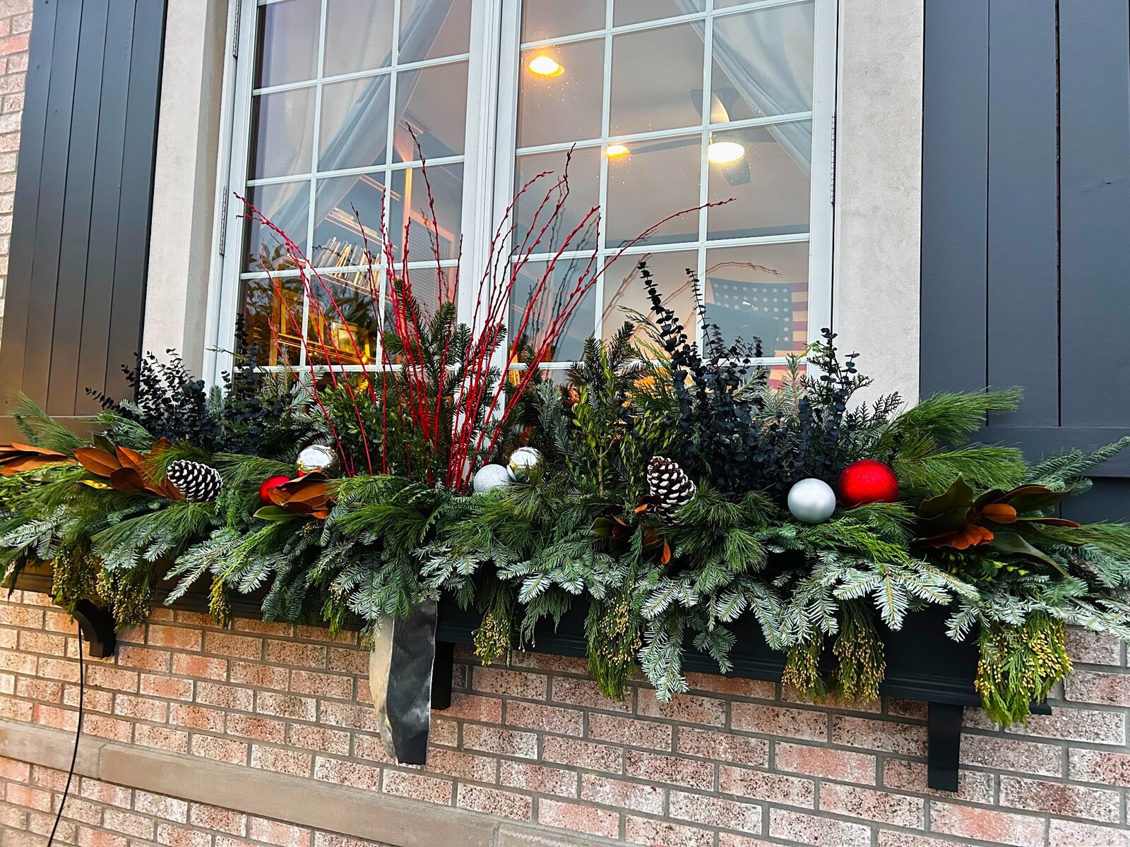 Holiday window greenery by M&J Landscaping